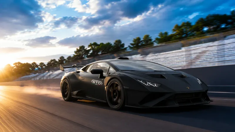 Matte Black Supercar Racing at Golden Hour wallpaper preview
